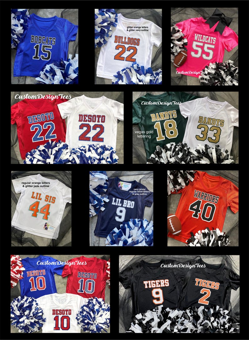 May include: Collection of youth sports jerseys in various colors, including blue, white, red, green, orange, and black. Each jersey features team names, numbers, and pom-poms. The jerseys are for teams like Bobcats, Bulldogs, Wildcats, and Tigers.
