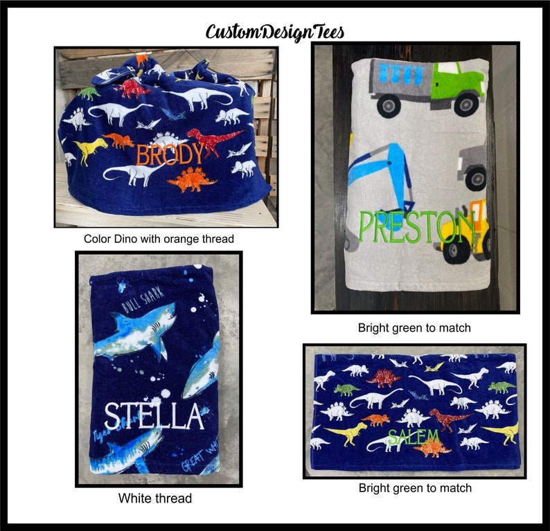May include: Four personalized towels and a drawstring bag are displayed. The bag is navy blue with dinosaur designs and the name "BRODY" in orange. One towel has construction vehicles and the name "PRESTON" in green. Another has sharks and the name "STELLA". The last towel has dinosaurs and the name "SALEM".
