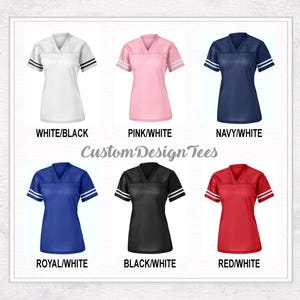 May include: Six v-neck jerseys with short sleeves and two stripes on each sleeve, labelled CustomDesignTees. Colours include white/black, pink/white, navy/white, royal/white, black/white, and red/white, each displayed with its respective colour name.