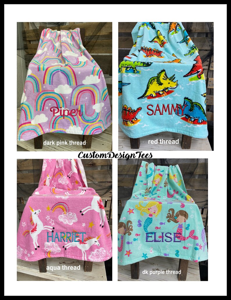 May include: Four personalized children's towels with embroidered names. The towels feature colorful designs: rainbows, dinosaurs, unicorns, and mermaids. The names Piper, Sammy, Harriet, and Elise are embroidered in dark pink, red, aqua, and dark purple thread.