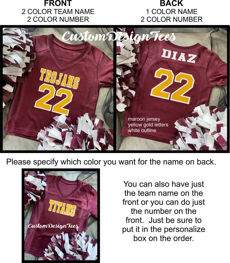 May include: Maroon jersey with yellow gold lettering and a white outline. The front displays "TROJANS" and the number "22". The back shows "DIAZ" and "22". The image also shows a jersey with "TITANS" on the front. Pom-poms are in the foreground.