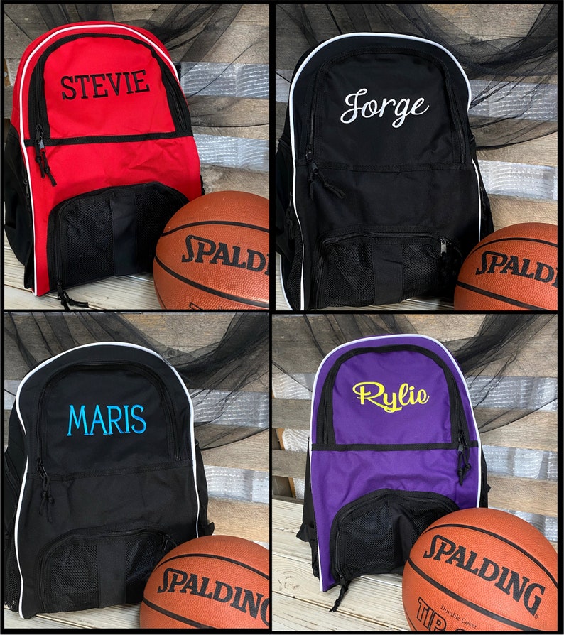 May include: Four personalized basketball backpacks with a basketball in front of each. The backpacks are red, black, black, and purple. The names on the backpacks are Stevie, Jorge, Maris, and Rylie.