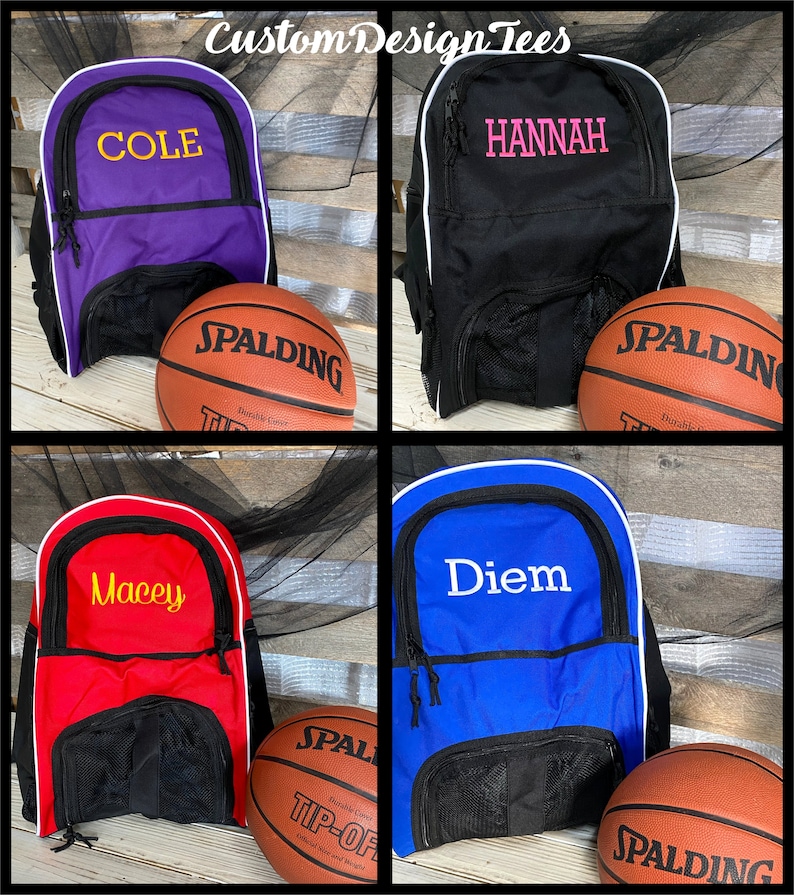 May include: Four different colored backpacks with white trim and black mesh pockets. Each backpack has a different name embroidered on the front in a contrasting color.  A basketball is in front of each backpack.