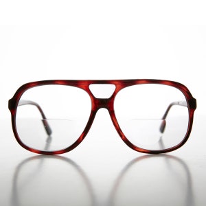 Puede incluir: Gafas de aviador de carey rojo con lentes transparentes.