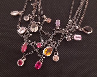 Colourful crystal necklaces made of thin silver chains and mismatched charms