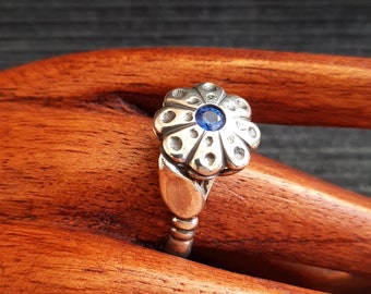 Silver flower ring with blue crystal