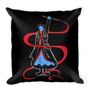 May include: Black throw pillow featuring a stylized illustration of a figure in a long coat, hat, and scarf, holding a spear. The figure is outlined in white, with red and blue accents against a starry background.