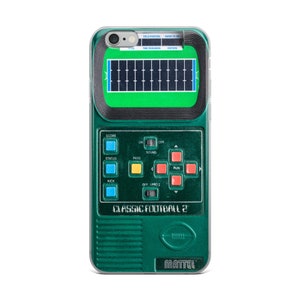May include: A green and black handheld electronic football game with a screen showing a football field. The game has buttons for score, status, pass, run, kick, on/off, and sound. The game is labeled "Classic Football 2" and "Mattel".