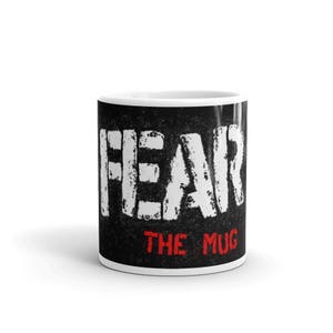 May include: White ceramic mug with a black background and the text "FEAR THE MUG" in white and red letters.