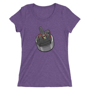 May include: Purple women's t-shirt with a graphic of a hand giving the middle finger. The hand is wearing a ring with a gemstone.