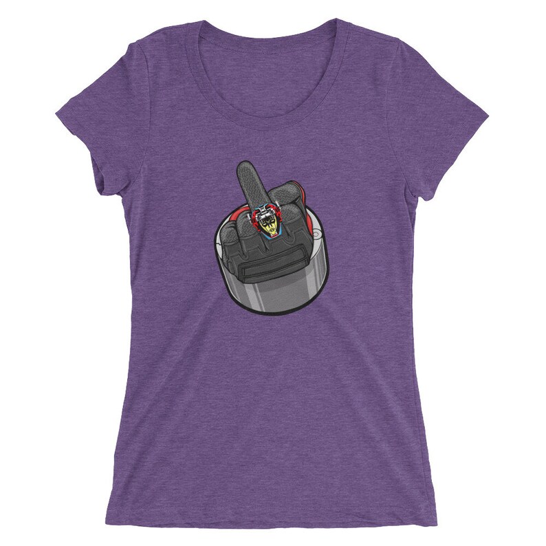 May include: Purple women's t-shirt with a graphic of a hand giving the middle finger. The hand is wearing a ring with a gemstone.