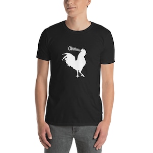 May include: Black t-shirt featuring a white silhouette of a rooster with the text "Ohhhhhhh" above it.