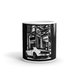 May include: Black and white illustration of a white car driving down a city street. The car is a classic muscle car with a black interior. The street is lined with brick buildings. The text "The Sand Bar" is visible on one of the buildings.