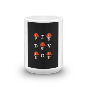 May include: White ceramic mug with a black background and a graphic of six red and orange construction hats with the letters "EDVDO" in white.