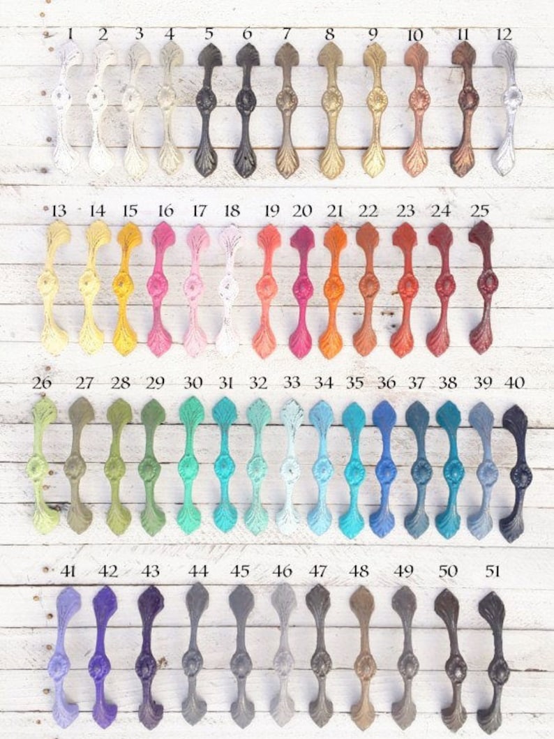 May include: A collection of 51 cabinet knobs with a variety of colors and finishes. The knobs are made of metal and have a decorative design. The knobs are numbered 1 through 51.