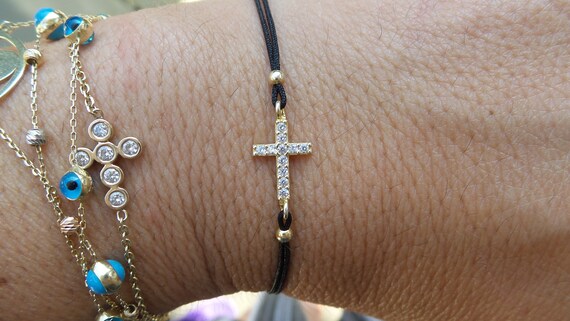 Mini Cross Bracelet with Sparkling Cubic Zirconia Rhodium on Silver Adjustable Length Mini Cross Bracelet with Sparkling Cubic Zirconia Rhodium on Silver Adjustable Length