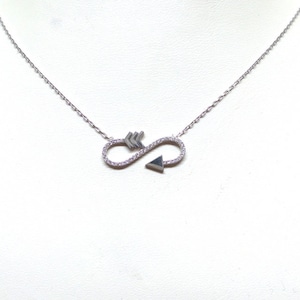 May include: Silver infinity necklace with a small arrow pendant. The pendant is set with small clear stones.