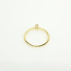 14k solid gold ring with a 4 prong set 0.10 carat 3 mm diamond .perfect as an everyday and stacking options, minimalistic promise ring displayed on a white background back view