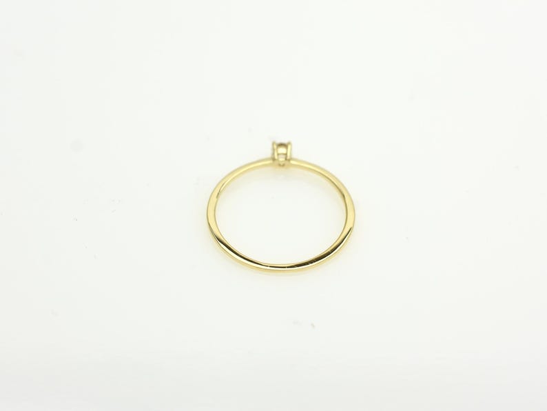 14k solid gold ring with a 4 prong set 0.10 carat 3 mm diamond .perfect as an everyday and stacking options, minimalistic promise ring displayed on a white background back view