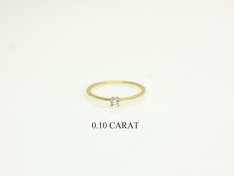 14k solid gold ring with a 4 prong set 0.10 carat 3 mm diamond .perfect as an everyday and stacking options, minimalistic promise ring displayed on a white background