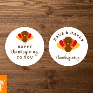 May include: Two round white printable gift tags with a cartoon turkey illustration. One tag says "Happy Thanksgiving to You" and the other says "Have a Happy Thanksgiving".