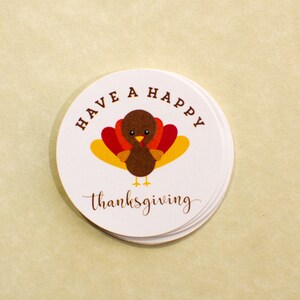 May include: A white round sticker with a brown turkey illustration and the text "Have a Happy Thanksgiving".