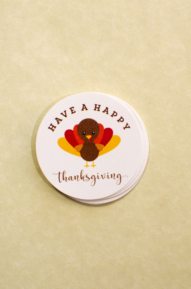 May include: A white round sticker with a brown turkey illustration and the text "Have a Happy Thanksgiving".