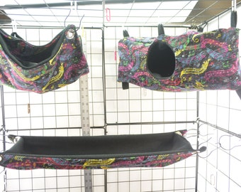 May include: Three colorful fabric pet hammocks with a musical note pattern. The hammocks are hanging from a black wire cage. The hammocks are black with a colorful musical note pattern.