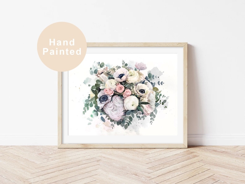 May include: A watercolour painting of a bouquet of white, pink, and blue flowers with green leaves. The flowers are arranged in a loose, natural style. The painting is framed in a simple wooden frame.