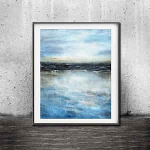 May include: A framed abstract painting of a seascape with blue and gray tones. The painting depicts a horizon with a body of water reflecting the sky.