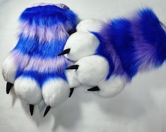 May include: A pair of blue and purple furry paw hand puppets with white claws.