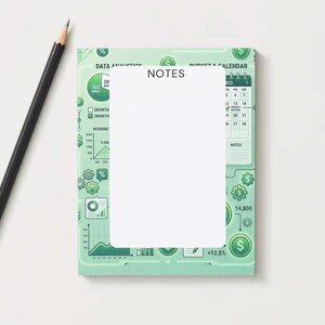 May include: A mint green notepad with data analytics and calendar graphics, the word "NOTES" is printed on the top. A black pencil with a gold ferrule lies to the left of the notepad. The notepad has a white blank space for writing.