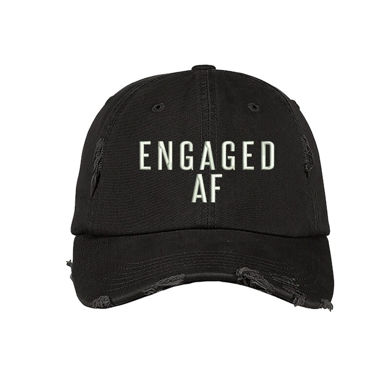 May include: Black distressed baseball cap with white embroidered text that reads "ENGAGED AF".