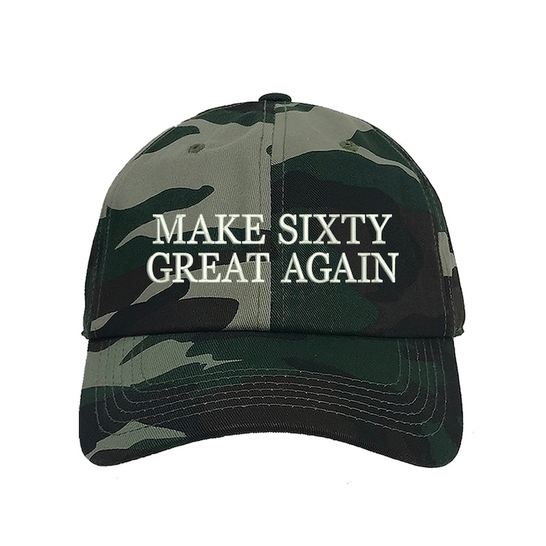 May include: A camouflage baseball cap with the text "MAKE SIXTY GREAT AGAIN" embroidered in white.