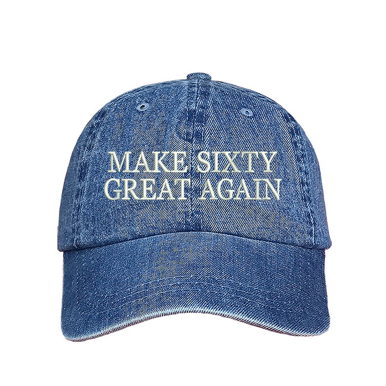 May include: A blue denim baseball cap with white embroidered text that reads "MAKE SIXTY GREAT AGAIN".