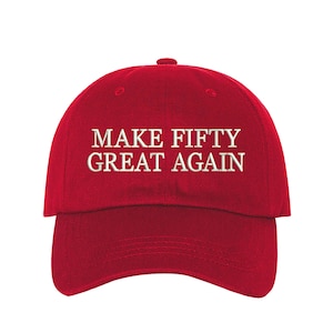 May include: Red baseball cap with white embroidered text that reads "MAKE FIFTY GREAT AGAIN".