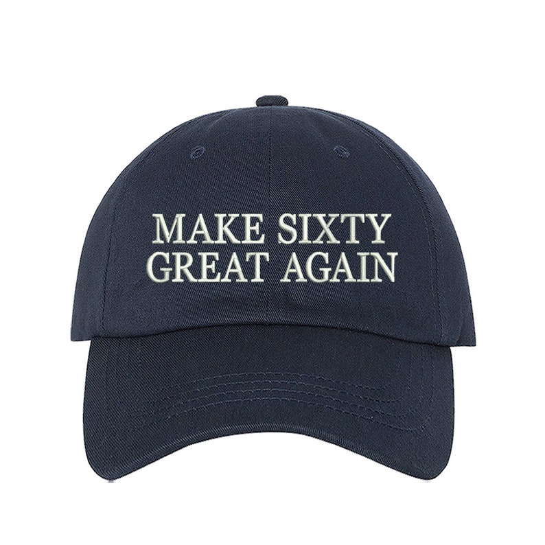 May include: A navy blue baseball cap with white embroidered text that reads "MAKE SIXTY GREAT AGAIN".