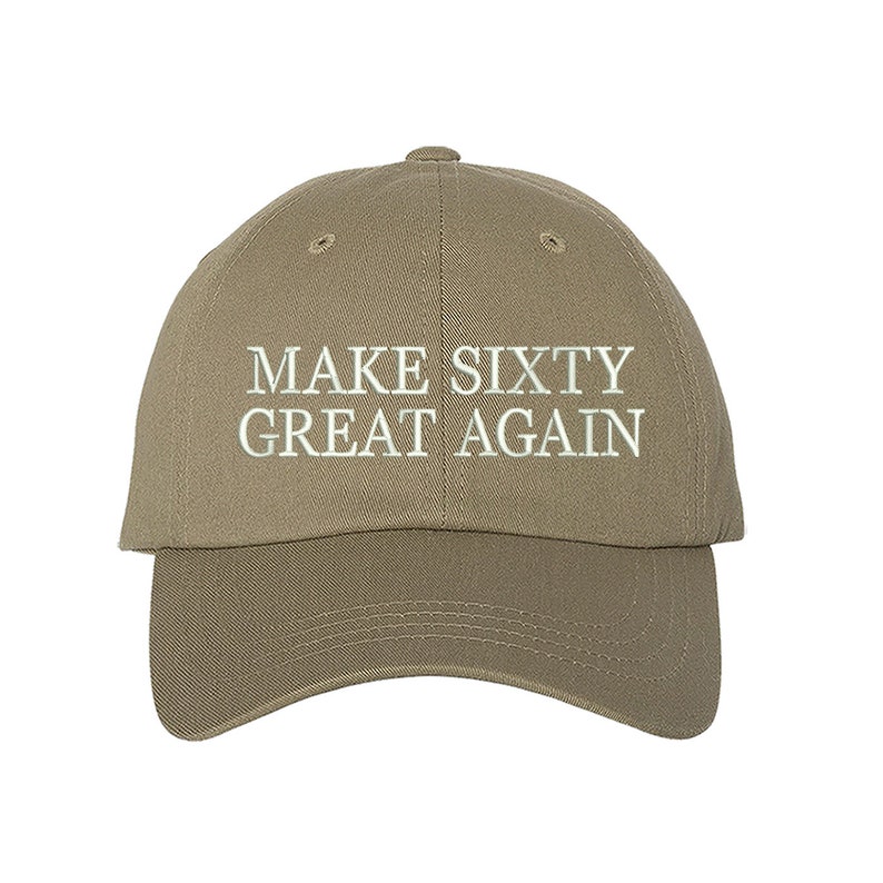 May include: A khaki baseball cap with the text "MAKE SIXTY GREAT AGAIN" embroidered in white.