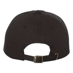 May include: A black baseball cap with a brown adjustable buckle closure.