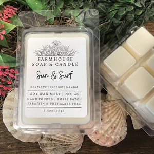 May include: A white soy wax melt in a clear plastic container with a label that reads "FARMHOUSE SOAP & CANDLE Sun & Surf HONEYDEW | COCONUT | JASMINE SOY WAX MELT | NO. 40 HAND POURED | SMALL BATCH PARAFFIN & PHTHALATE FREE 2.5oz (70g)"