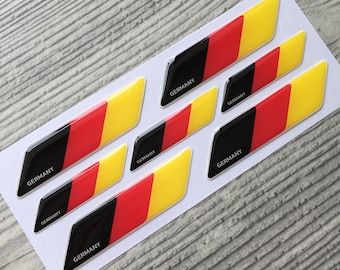 May include: Seven black, red, and yellow German flag decals with the word "GERMANY" printed on each one.