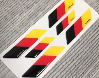 May include: Six black, red, and yellow German flag decals. Each decal has the word "GERMANY" printed on it.