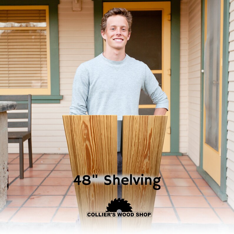 May include: A man stands in front of two pieces of unfinished wood shelving, each measuring 48 inches in length. The wood is a light brown color with a natural grain pattern. The text "48" Shelving" and "COLLIER'S WOOD SHOP" is printed on the wood.