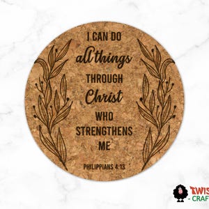 May include: Round cork coaster with the text "I CAN DO all things THROUGH Christ WHO STRENGTHENS ME" and "PHILIPPIANS 4:13" in black. The coaster has a brown background and a decorative leaf design.