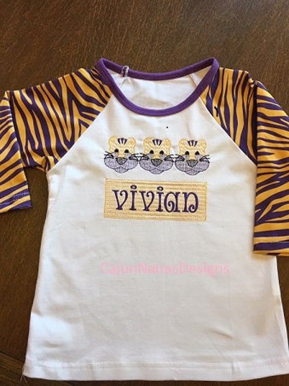 purple and gold raglan shirt