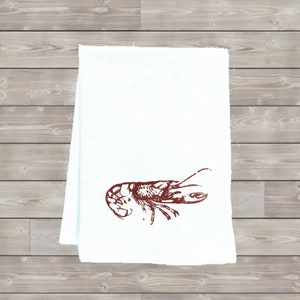 May include: White kitchen towel with a red illustration of a lobster.