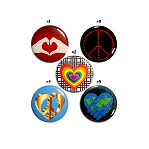 May include: Five round buttons with different peace and love themed designs. The buttons are numbered 1 through 5. Button 1 features a red heart with hands forming a heart shape. Button 2 features a rainbow heart with a black and white checkered background. Button 3 features a black peace sign with red dots. Button 4 features a gold peace sign. Button 5 features a blue globe with hands forming a heart shape.