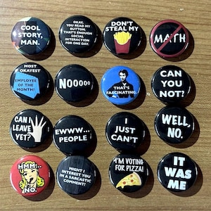 May include: A set of 16 round button pins with various sayings and images. The buttons are black, red, blue, and white with white text. Some of the sayings include "Cool story, man", "Don't steal my math", "Most okayest employee of the month", "N00000", "That's fascinating", "Can you not?", "Can I leave yet?", "Ewww... people", "I just can't", "Well, no", "Hmm... no", "Might I interest you in a sarcastic comment?", "I'm voting for pizza!" and "It was me".