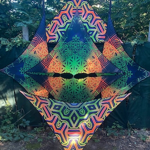May include: Three triangular tapestries with intricate geometric patterns in shades of green, orange, and purple. The tapestries are made of a black fabric and have a shiny, iridescent finish.