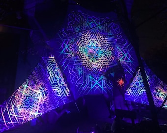 May include: A large, colourful, geometric patterned fabric canopy with glowing neon lights. The fabric is draped over a structure and is illuminated with a variety of colours, including pink, blue, green, and purple.